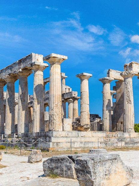 Ancient Temple of Aphaia on Aegina Island under blue sky.
