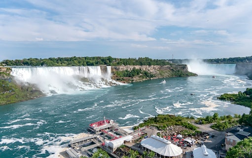 Aerial view of Horseshoe Falls at Niagara with tour boats and observation deck.