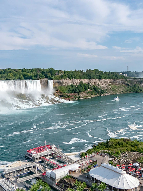 Aerial view of Horseshoe Falls at Niagara with tour boats and observation deck.
