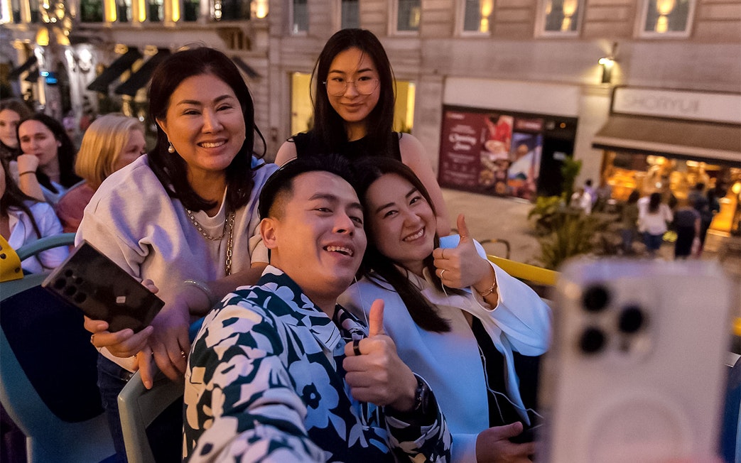 Group enjoying a night tour on a double-decker bus in London.