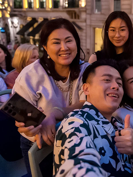 Group enjoying a night tour on a double-decker bus in London.