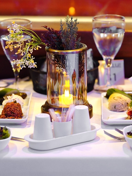 Turkish dinner spread on a table with candlelight during Bosphorus Dinner Cruise.