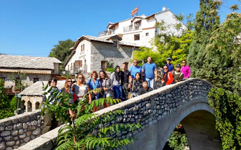 Tourists exploring Kriva ćuprija bridge in Mostar