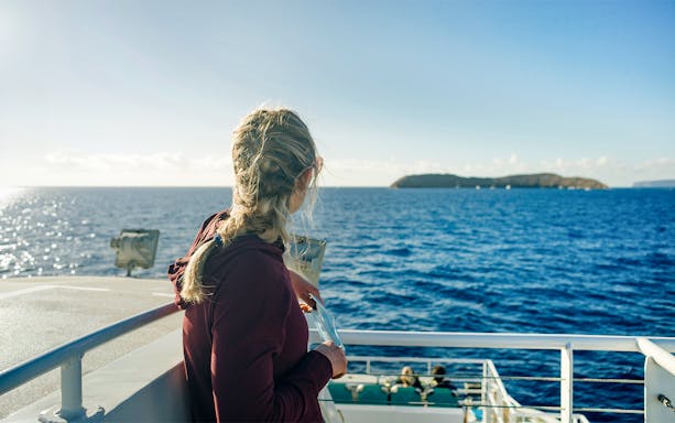 Woman enjoying ocean view on Molokini & Turtle Arches Snorkel cruise.