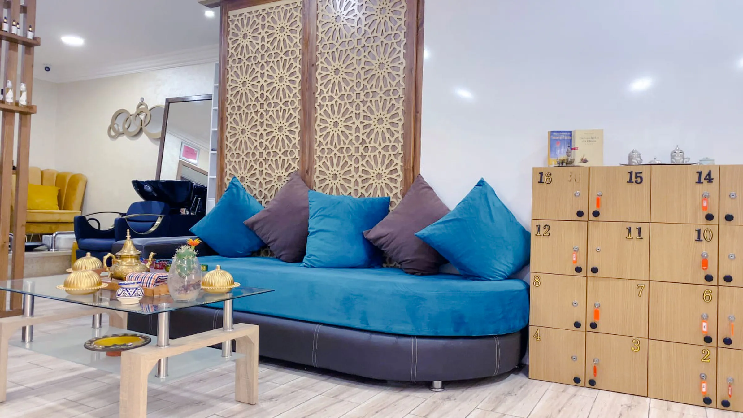 Traditional Moroccan hammam lounge with seating, decorative screen, and tea set in Agadir spa.