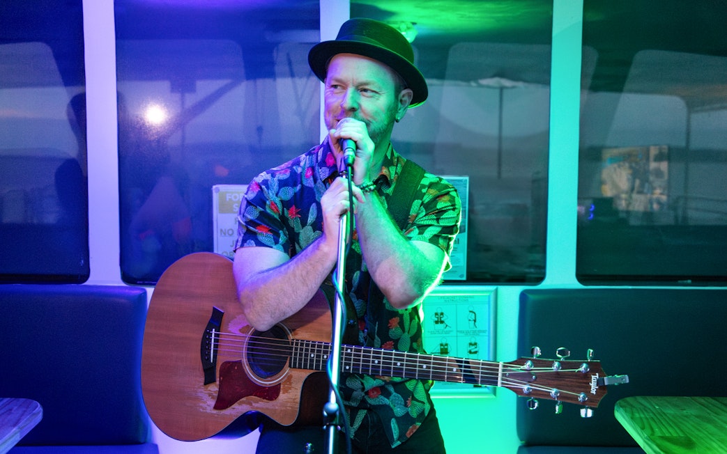 Musician performing on a Sunset Sightseeing Cruise at Phillip Island.