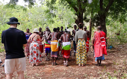 Maasai group performing cultural dance under trees at Diani Beach.
