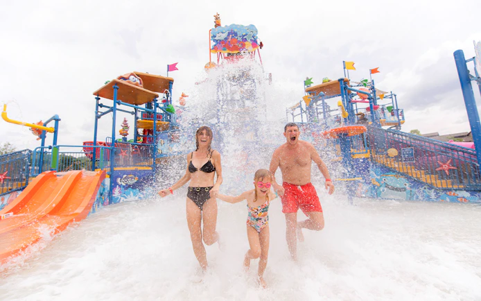 Family enjoying water splash at Andamanda Phuket Water Park.