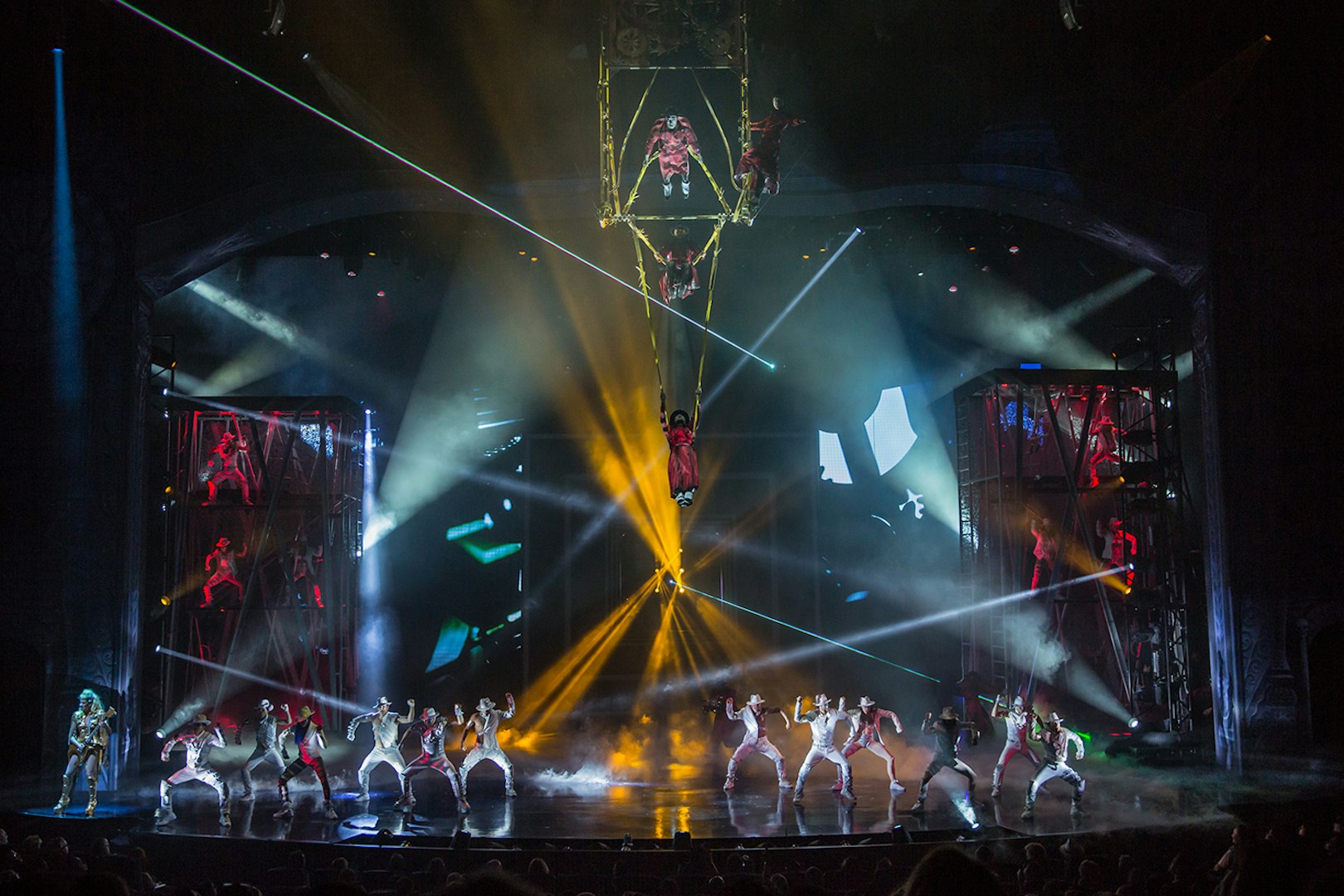 Performers on stage with vibrant lights at Michael Jackson ONE show.