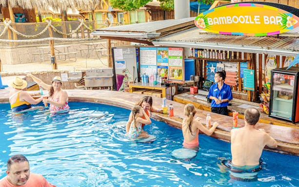 Guests enjoying drinks at Bamboozle Bay swim-up bar, Schlitterbahn New Braunfels.