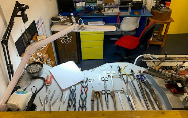 Jewelry tools arranged on a workbench at a Sardinian filigree workshop in Dorgali.