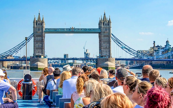 Sightseeing cruise on the Thames River with view of Tower Bridge, London.