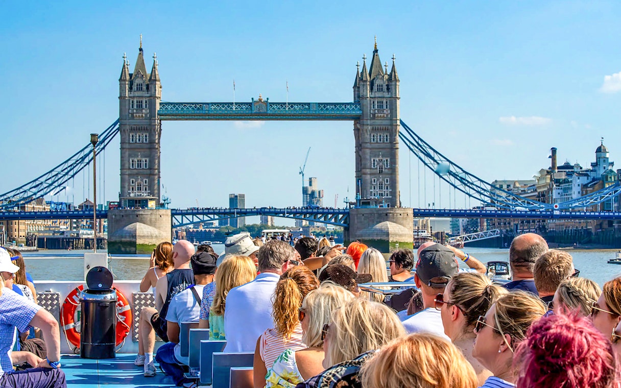 Sightseeing cruise on the Thames River with view of Tower Bridge, London.