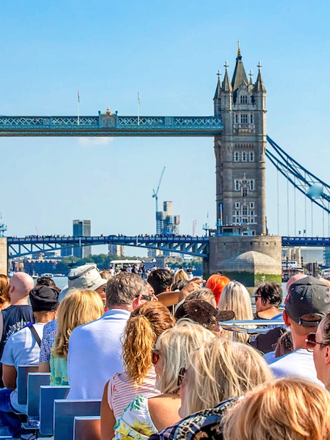 Sightseeing cruise on the Thames River with view of Tower Bridge, London.