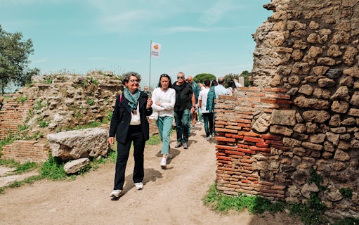 Visitors exploring Paestum Archaeological Site on a guided tour, Italy.