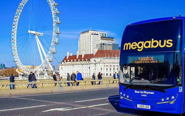 Megabus in front of the London Eye, offering airport transfer service.