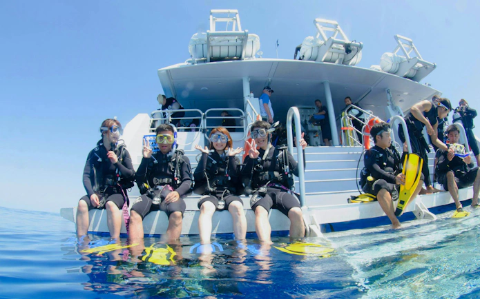 Divers preparing for a dive from a boat on the Great Barrier Reef during a 4-day PADI course from Cairns.