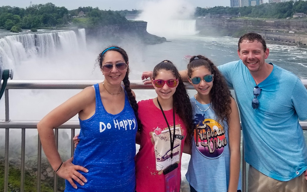 Visitors at Niagara Falls with Horseshoe Falls in the background during a winter tour.