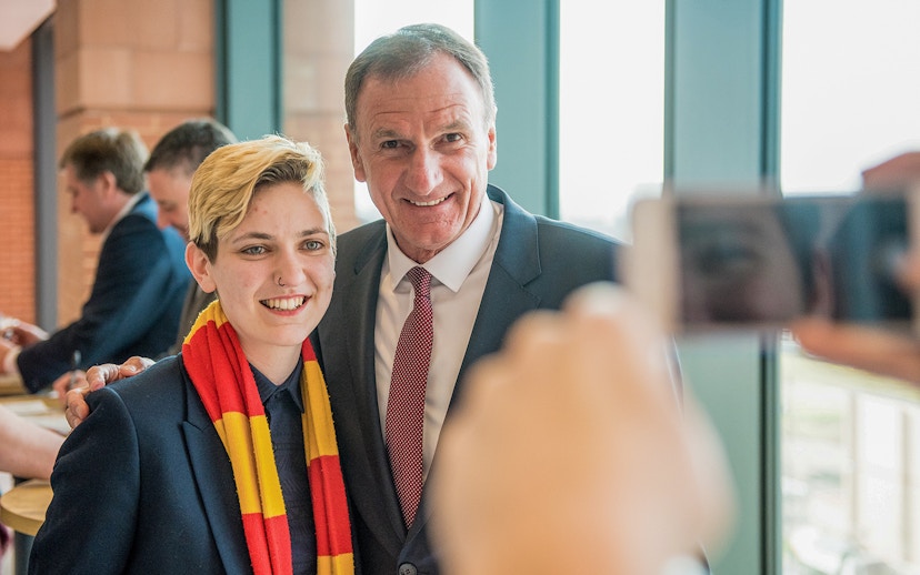 Liverpool FC Legends Q&A attendee posing with a former player during the stadium tour.