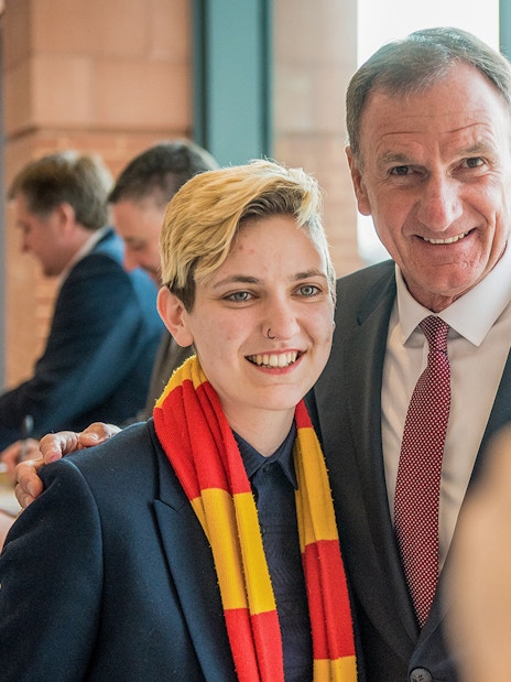 Liverpool FC Legends Q&A attendee posing with a former player during the stadium tour.