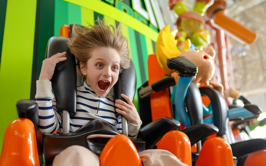 Kid enjoying the Skyline Scream ride at Nickelodeon Universe.