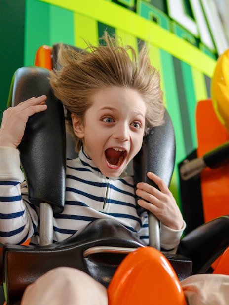Kid enjoying the Skyline Scream ride at Nickelodeon Universe.