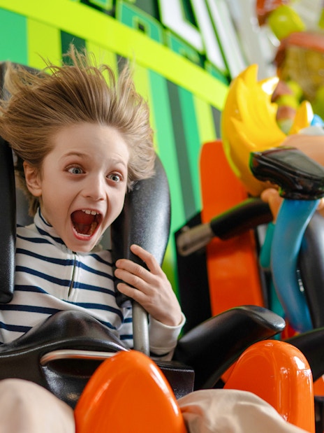 Kid enjoying the Skyline Scream ride at Nickelodeon Universe.