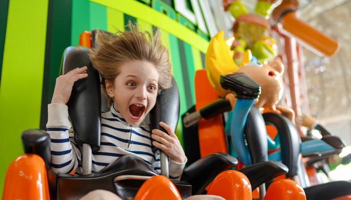 Kid enjoying the Skyline Scream ride at Nickelodeon Universe.