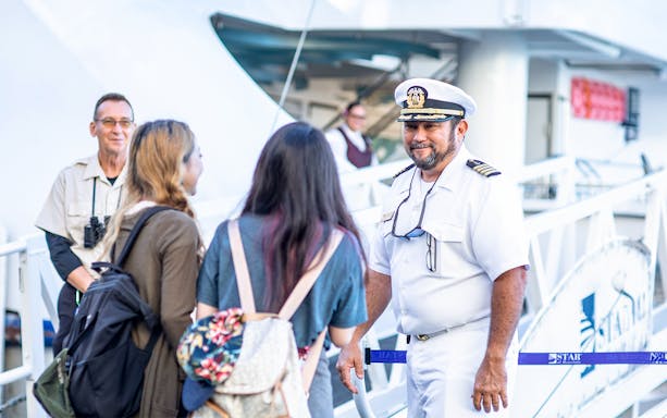 Cruise captain welcoming guests onboard in Oahu.