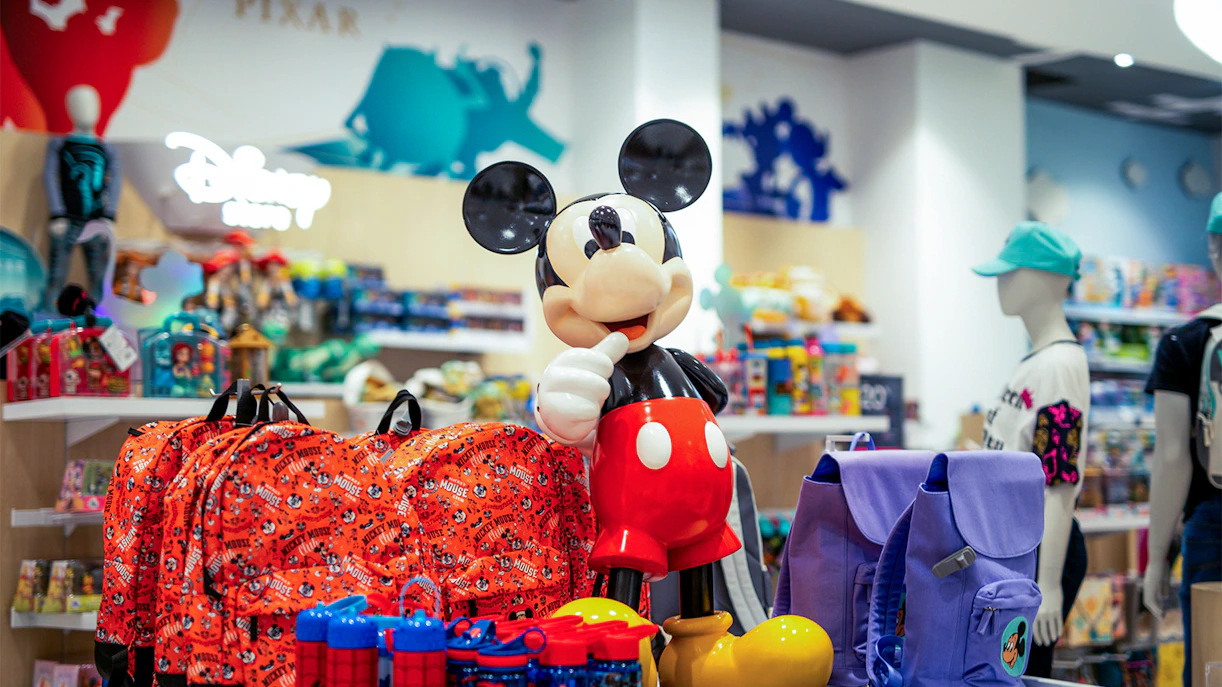 Mickey Mouse statue surrounded by merchandise at Disney World shop in Orlando.