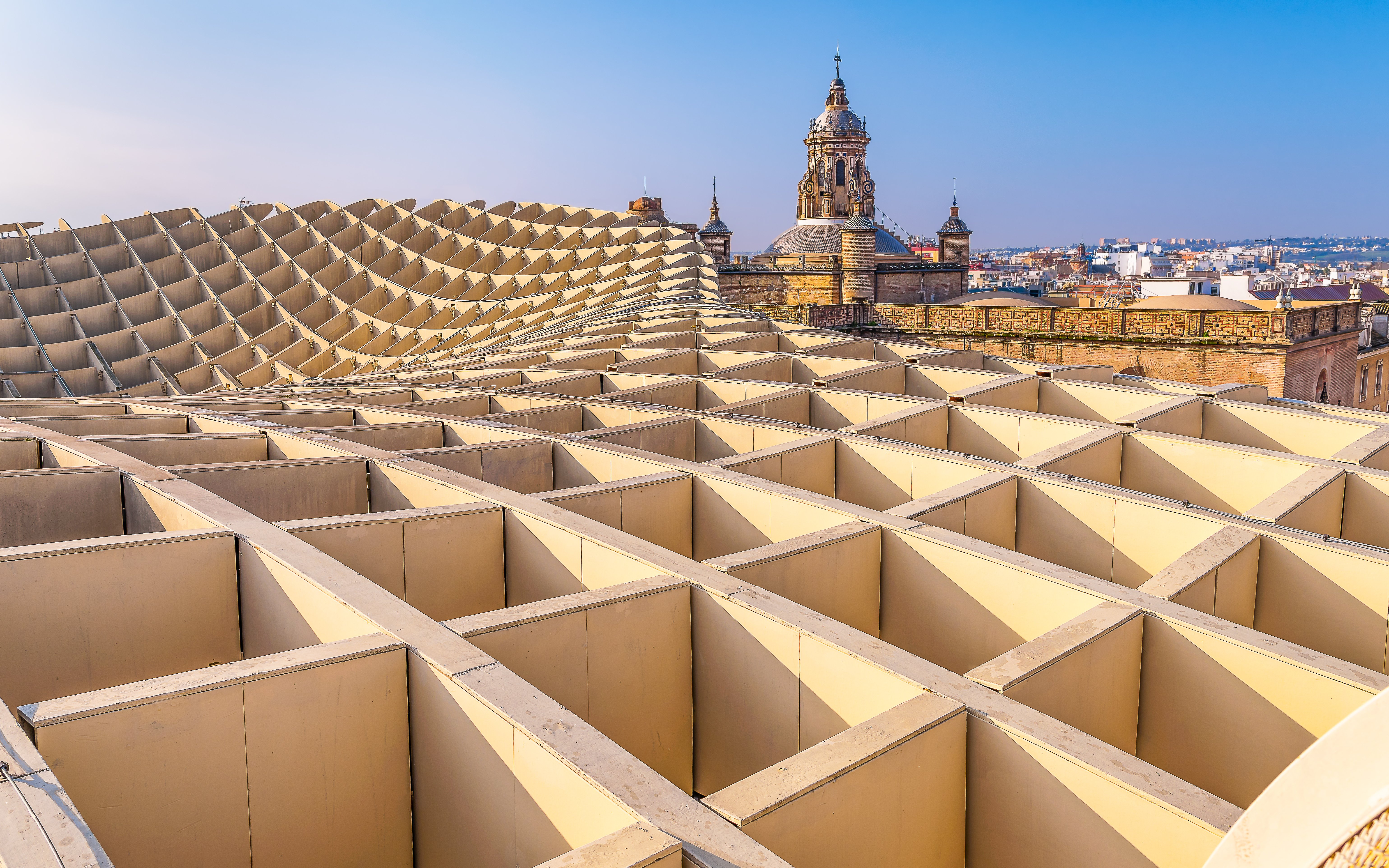 View from Las Setas in Seville with historic church tower in the background.