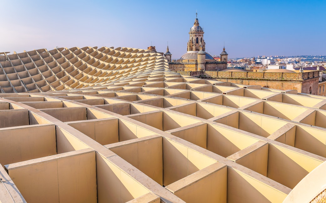 View from Las Setas in Seville with historic church tower in the background.