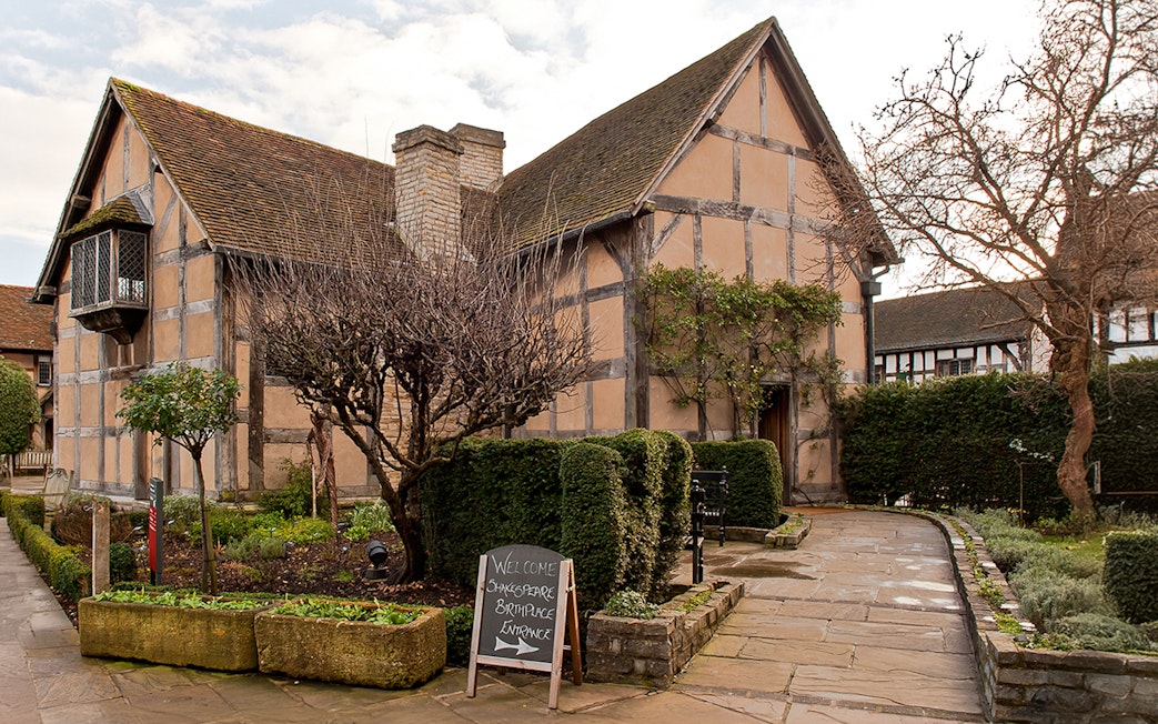 Shakespeare's Birthplace in Stratford with garden path and entrance sign.