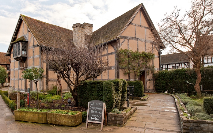 Shakespeare's Birthplace in Stratford with garden path and entrance sign.