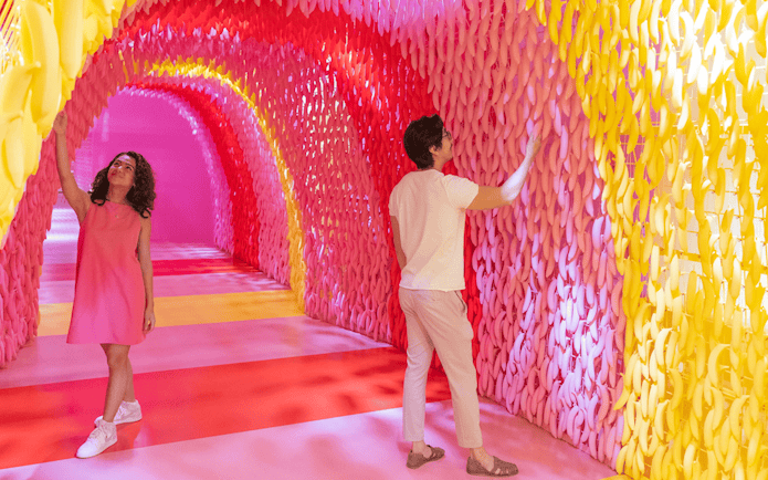Visitors exploring colorful banana exhibit at Museum of Ice Cream Singapore.