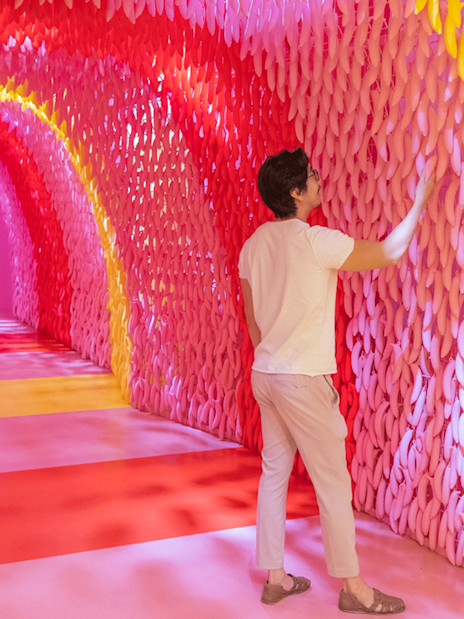 Visitors exploring colorful banana exhibit at Museum of Ice Cream Singapore.
