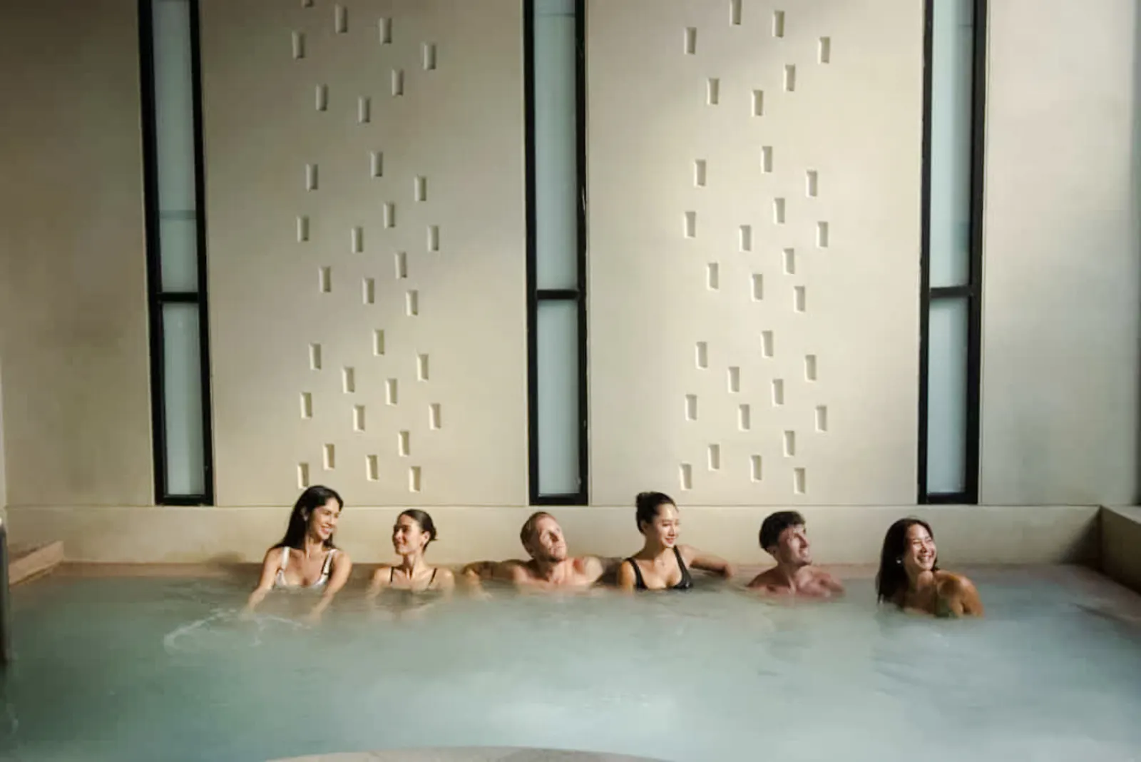 Visitors relaxing in a hot spring pool at Yunomori Onsen & Spa, Pattaya.