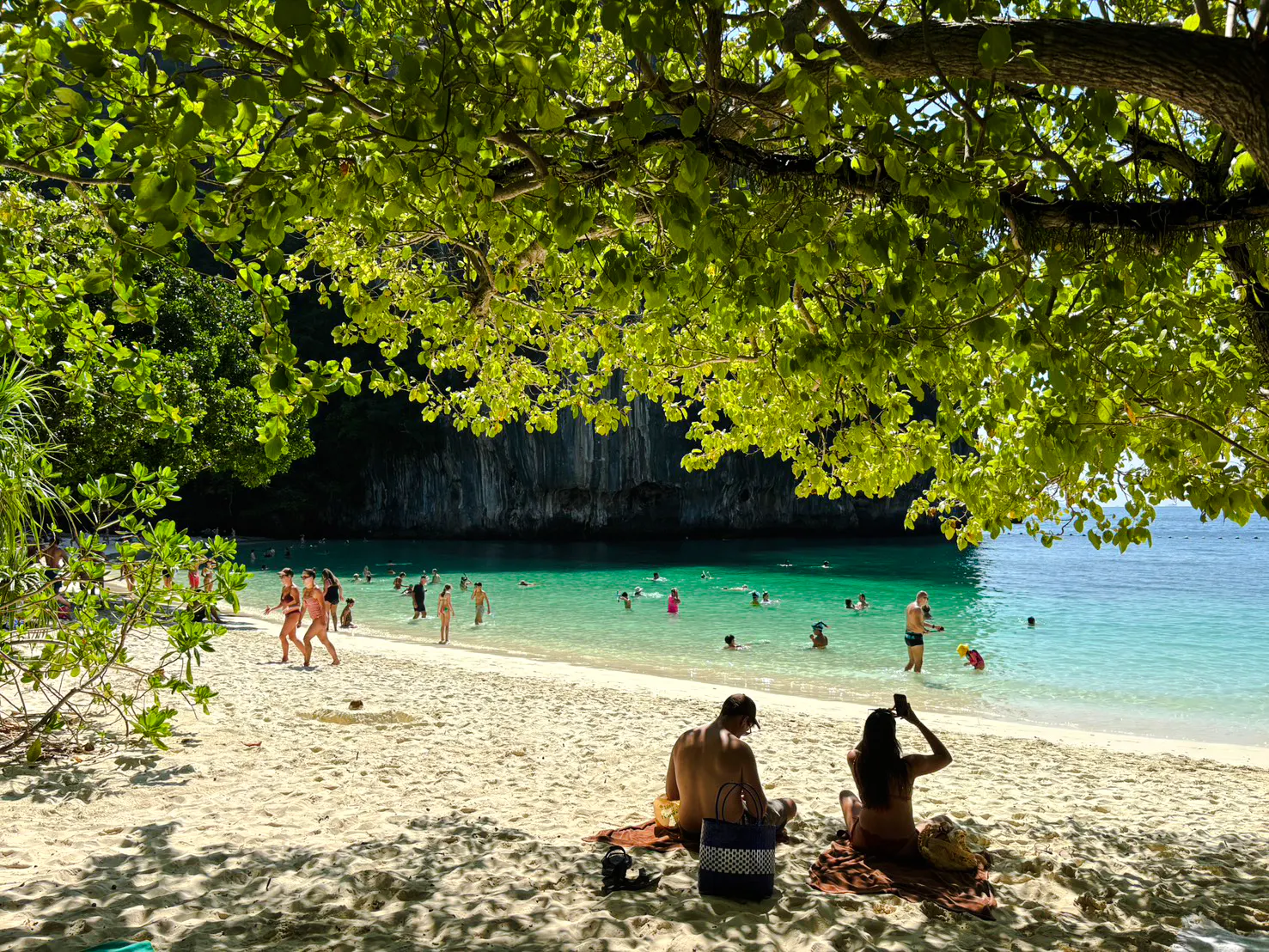 Tourists enjoying the beach and clear waters at Hong Islands, Krabi.
