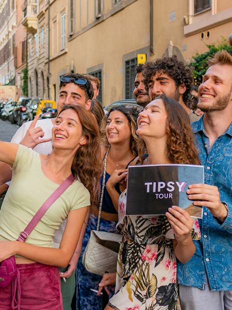 Group taking a selfie on a Rome guided tour in a cobblestone street.