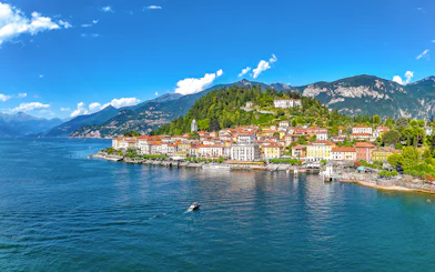 Aerial view of Bellagio village on Lake Como with colorful buildings and surrounding mountains.