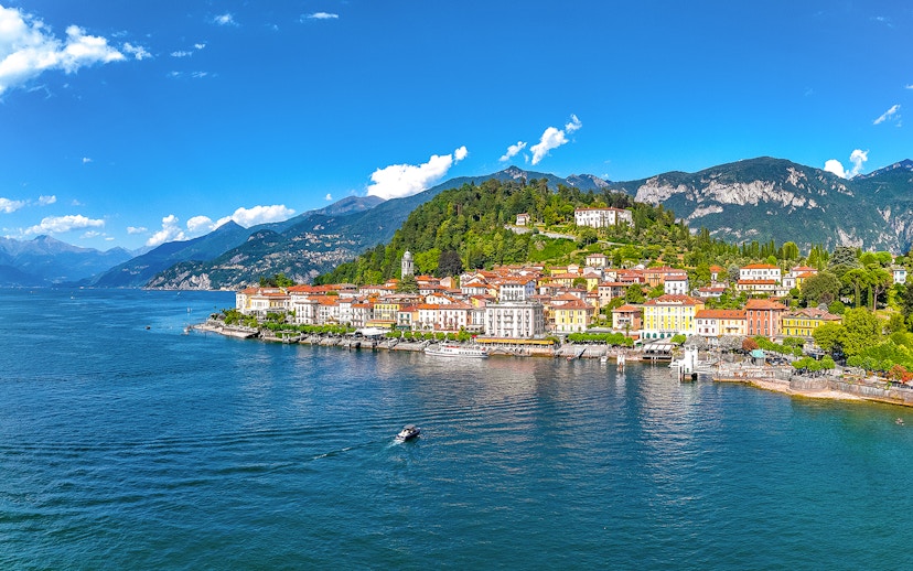 Aerial view of Bellagio village on Lake Como with colorful buildings and surrounding mountains.