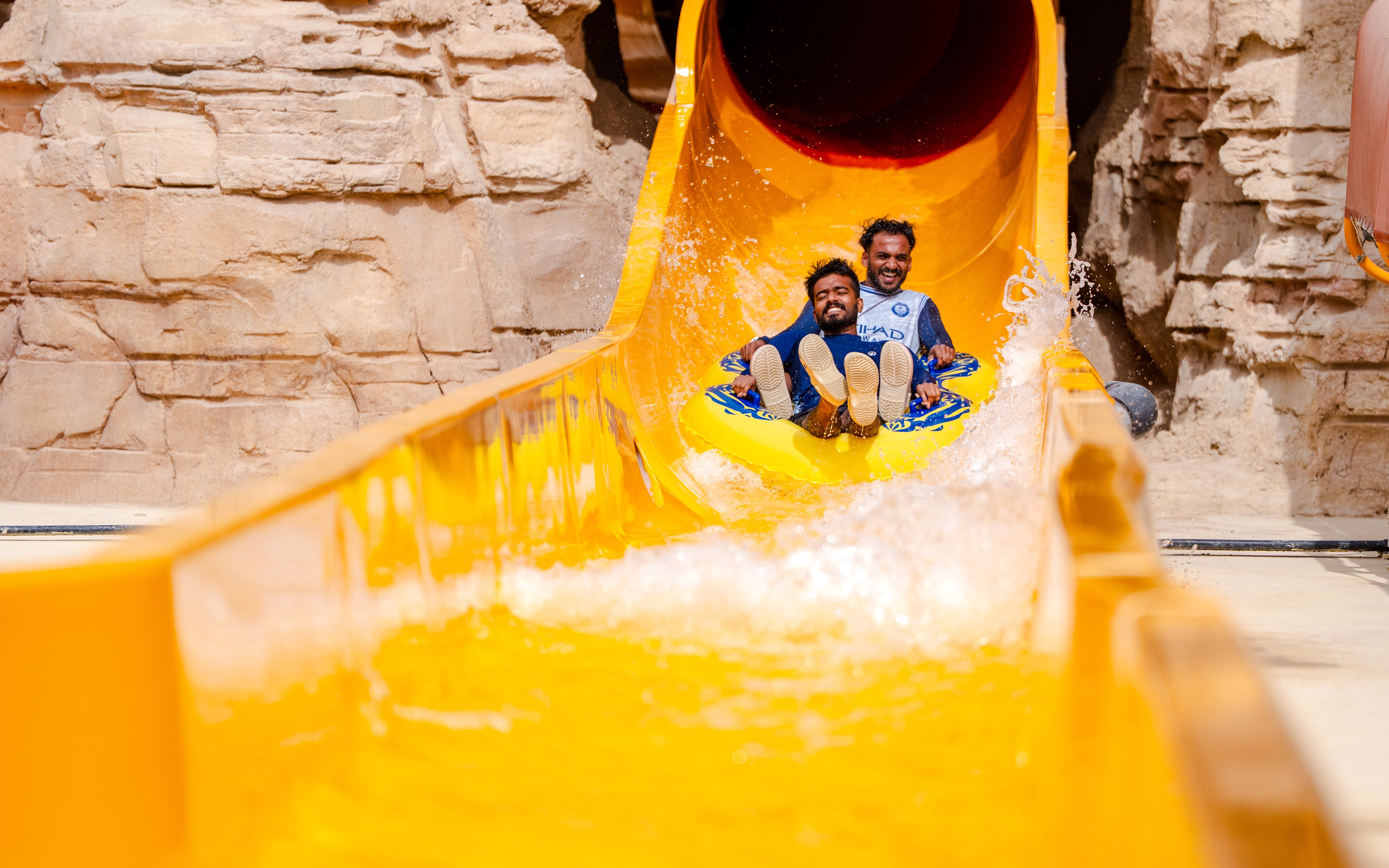 Visitors enjoying a water slide at Aquarabia Water Theme Park, Qiddiya City, Saudi Arabia.