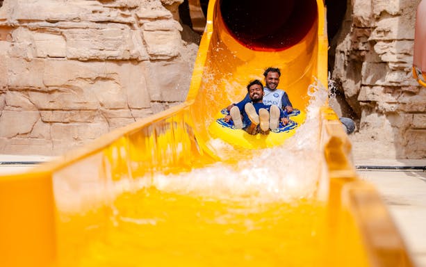 Visitors enjoying a water slide at Aquarabia Water Theme Park, Qiddiya City, Saudi Arabia.