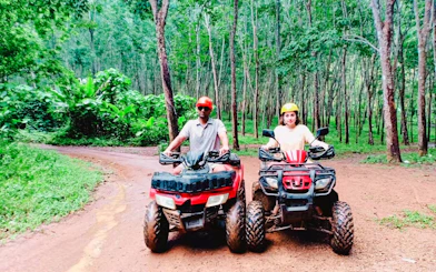 Two people on ATVs in a forest during Krabi ATV Adventure, Krabi.