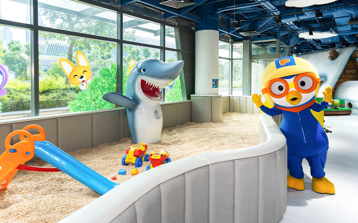 Pororo character and shark statue in play area at Pororo Park Singapore.