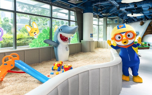 Pororo character and shark statue in play area at Pororo Park Singapore.