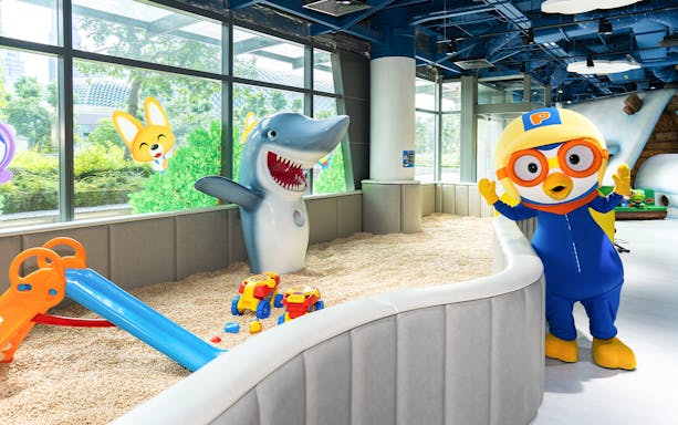 Pororo character and shark statue in play area at Pororo Park Singapore.