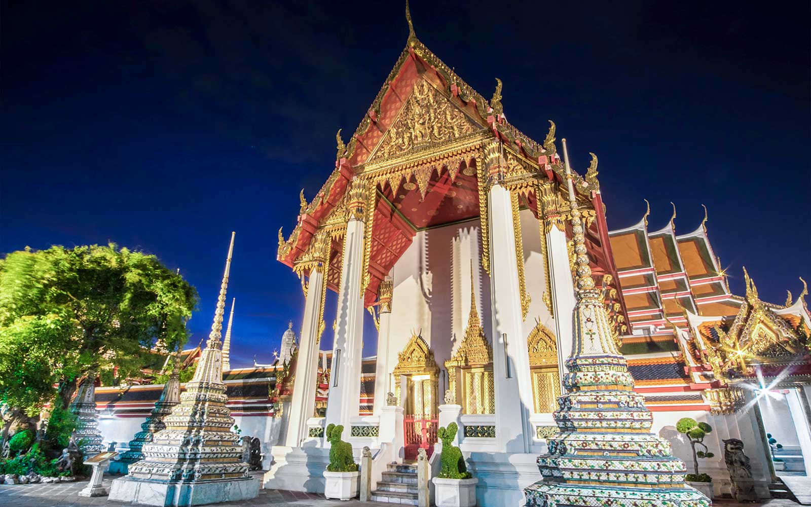Wat Pho temple illuminated at night during a Bangkok night bike tour.