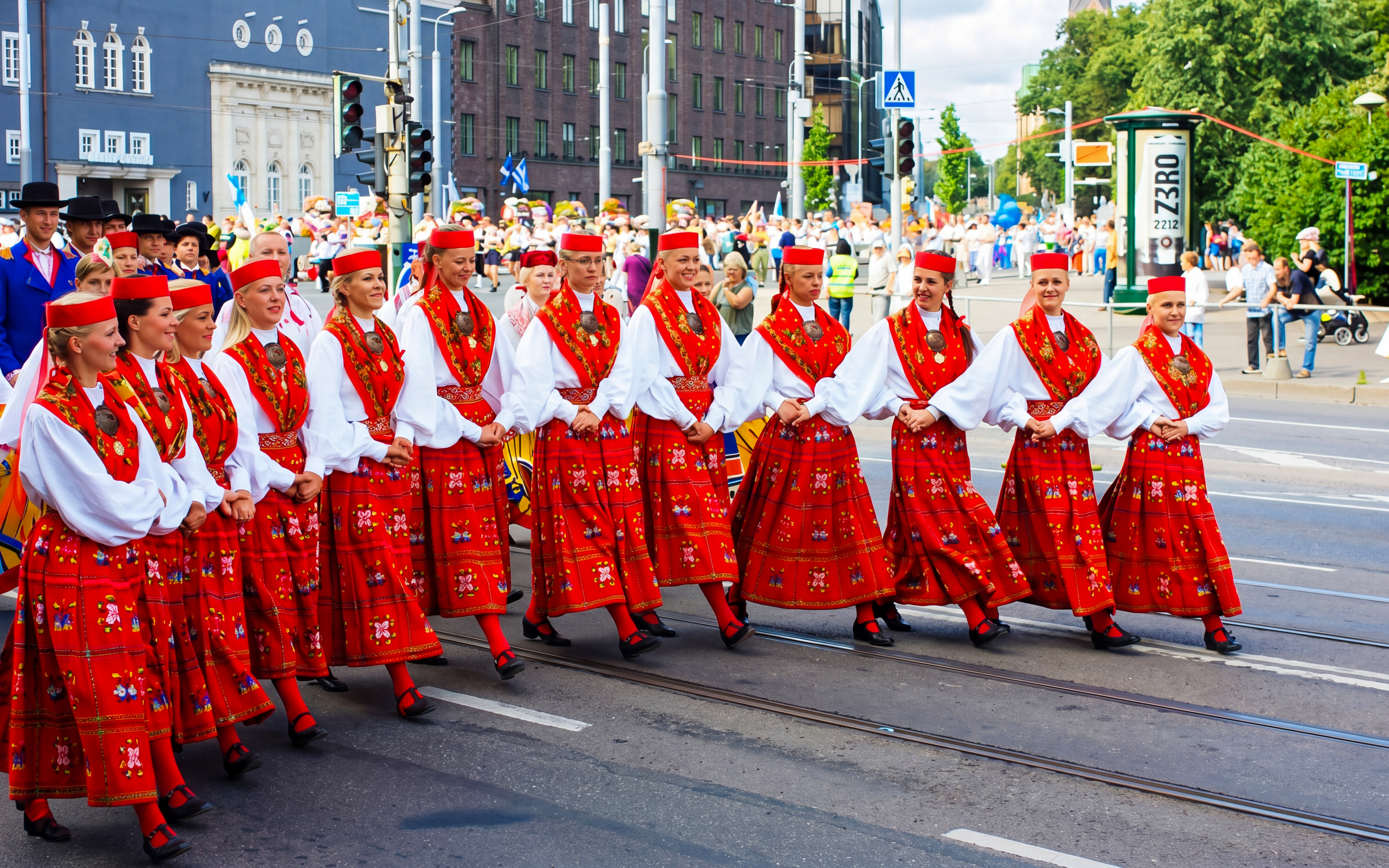 Performers in traditional red costumes at Tallinn Song Festival parade.