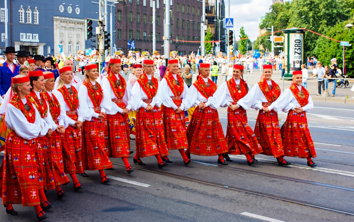 Performers in traditional red costumes at Tallinn Song Festival parade.